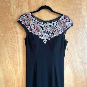 Formal mermaid style dress with embroidered floral design and crystal accents.